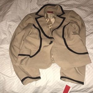 A junior’s khaki blazer with black detailed trim.